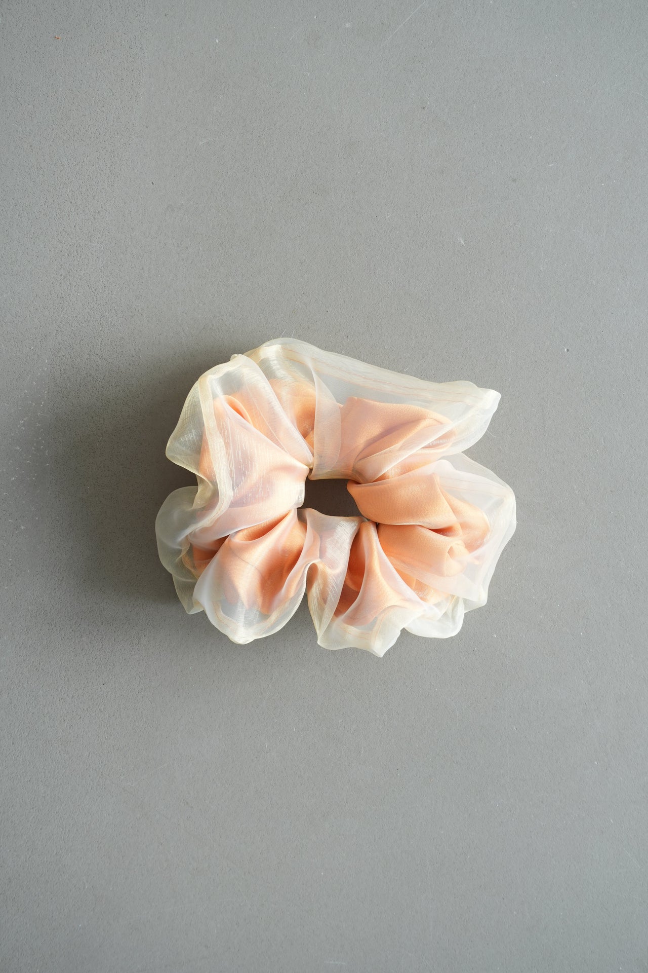 Pink scrunchie on a gray background